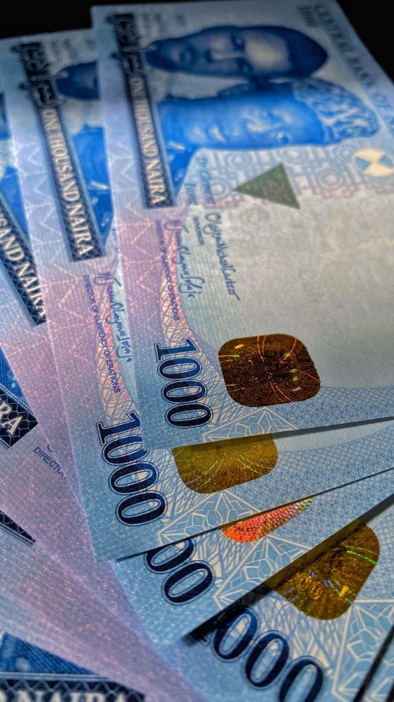 Nigerian Naira 1000 Naira notes representing beauty salon budget and makeup costs in Abuja